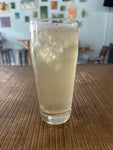 Glass of k-tea with ice on a wooden table, blurred background