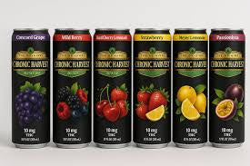 Six cans of 'Chronic Harvest' juice drinks with different fruit graphics on a black background