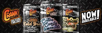 Crank energy drink packaging with various flavors on a black background
