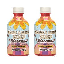 Two bottles of hazelnut syrup with cannabis leaves and the label indicates 1000mg THC.